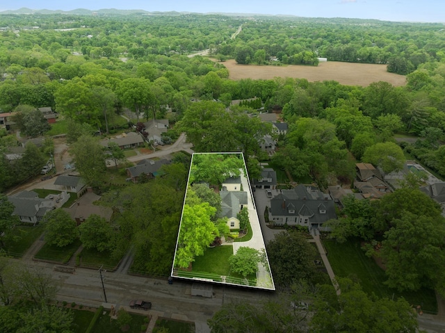 drone / aerial view with a residential view and a wooded view