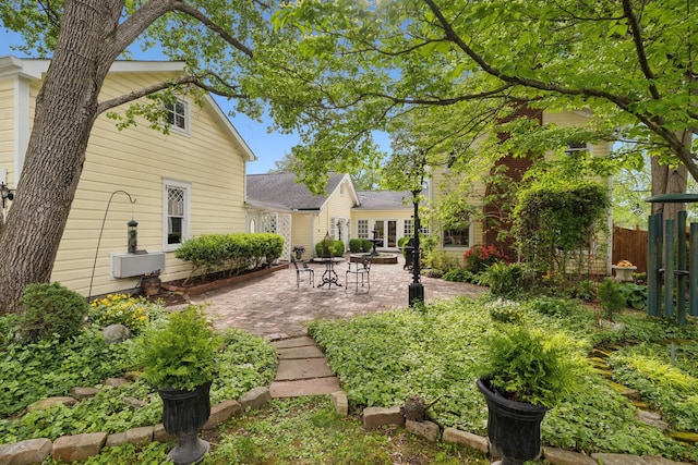 back of property featuring fence and a patio