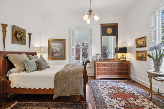 bedroom featuring baseboards and wood finished floors