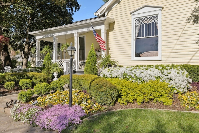view of exterior entry featuring a porch