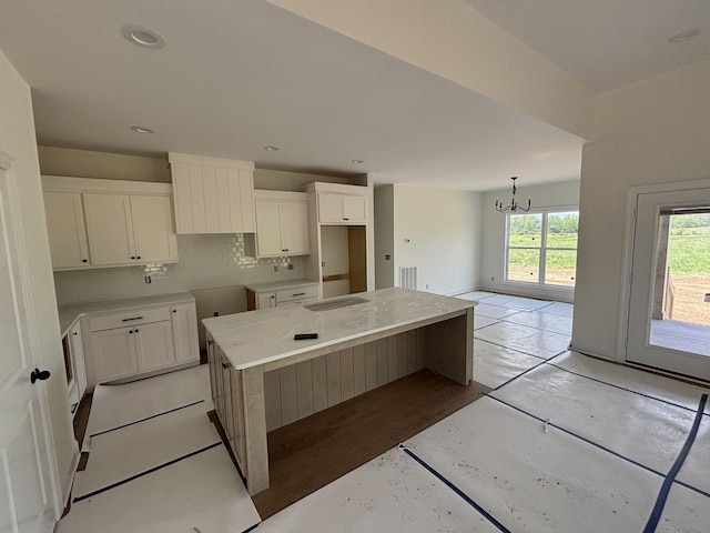 0 Short Mountain Rd, Woodbury, TN 37190 - kitchen featuring white cabinets, an inviting chandelier, light wood-style floors, a center island, and visible vents