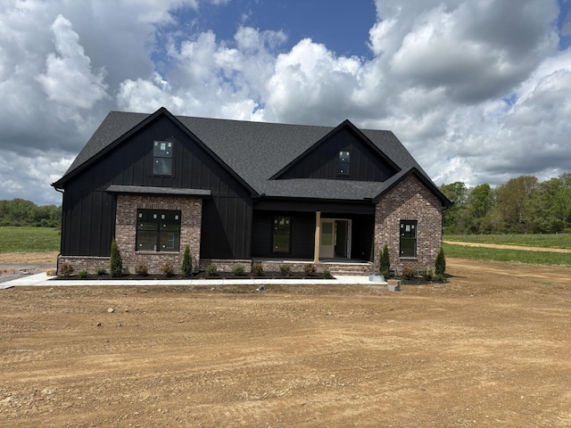 0 Short Mountain Rd, Woodbury, TN 37190 - view of front facade featuring brick siding, board and batten siding, roof with shingles, and covered porch
