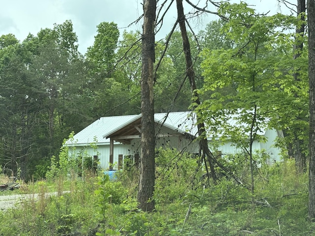 232 Moore Hollow Rd, Dickson, TN 37055 - view of side of property featuring metal roof and a wooded view