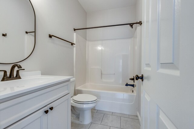 bathroom with tile patterned flooring, bathing tub / shower combination, toilet, and vanity