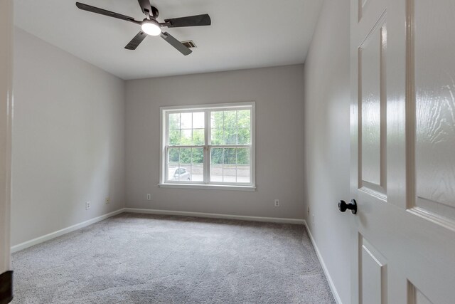 unfurnished room with a ceiling fan, baseboards, visible vents, and carpet