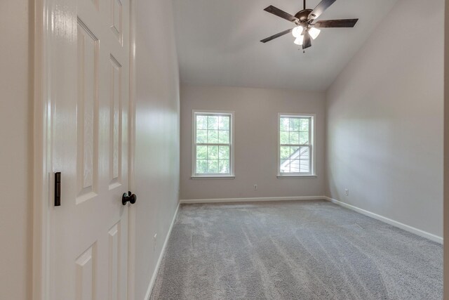 carpeted spare room with baseboards, ceiling fan, and lofted ceiling