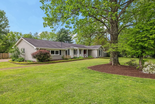 ranch-style home with fence, a front lawn, and brick siding