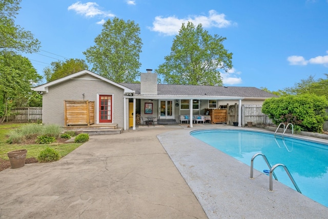 view of pool with a fenced in pool, a patio area, and fence