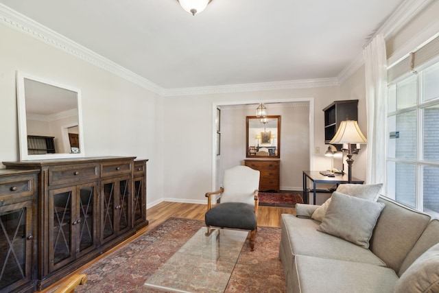living room with baseboards, ornamental molding, and wood finished floors