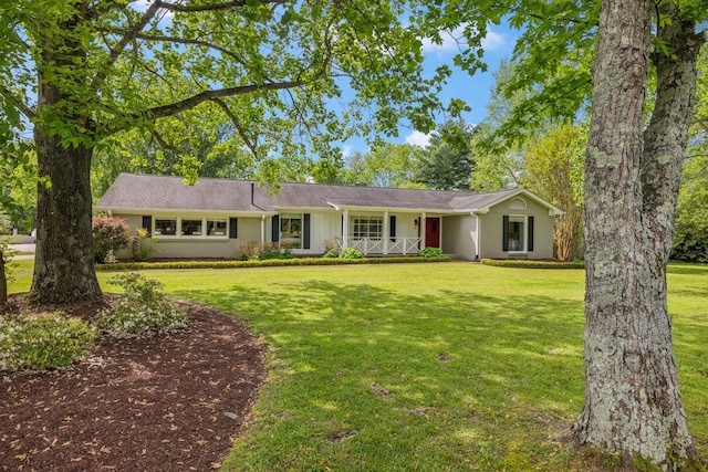 single story home featuring a porch and a front yard