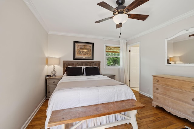 bedroom with baseboards, ornamental molding, ceiling fan, and wood finished floors