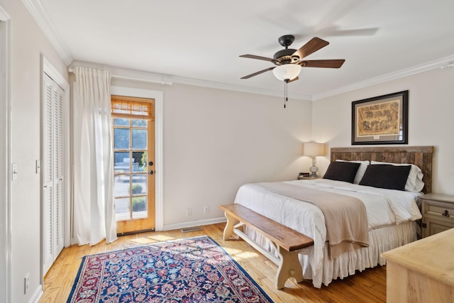 bedroom with crown molding, baseboards, visible vents, and wood finished floors