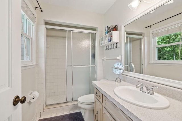full bathroom with vanity, toilet, and a stall shower