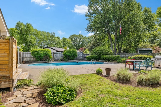 view of pool featuring a yard, a patio, a fenced in pool, and a fenced backyard
