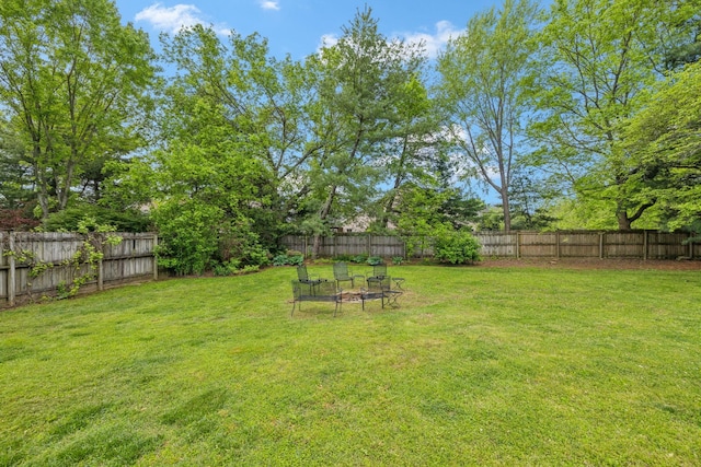 view of yard with a fenced backyard and an outdoor fire pit