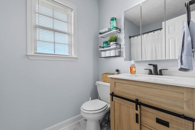 bathroom featuring vanity, marble finish floor, toilet, baseboards, and a shower with shower curtain
