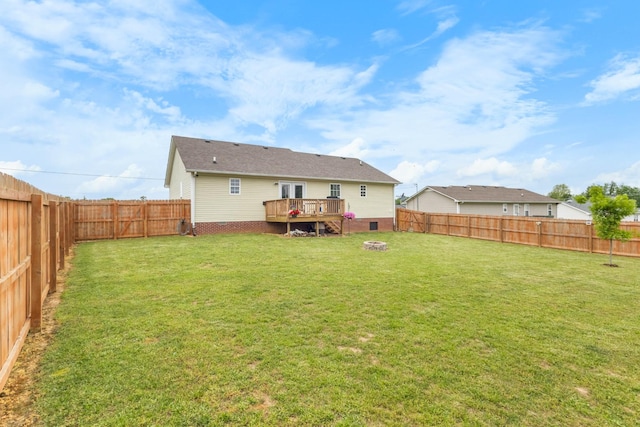 rear view of house featuring a fenced backyard, crawl space, a yard, and a deck