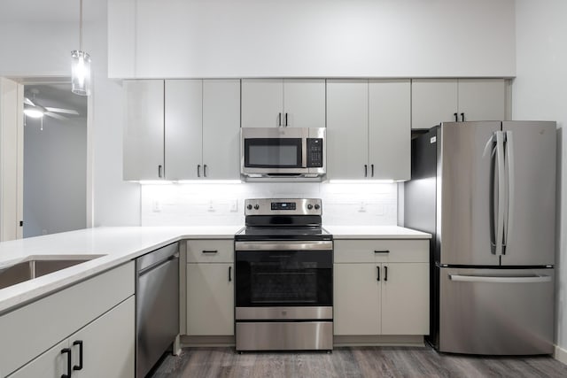 1014 16th Ave S Unit 202, Nashville, TN 37212 - kitchen featuring light countertops, decorative backsplash, wood finished floors, and stainless steel appliances