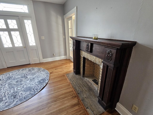 foyer with baseboards and light wood-style flooring