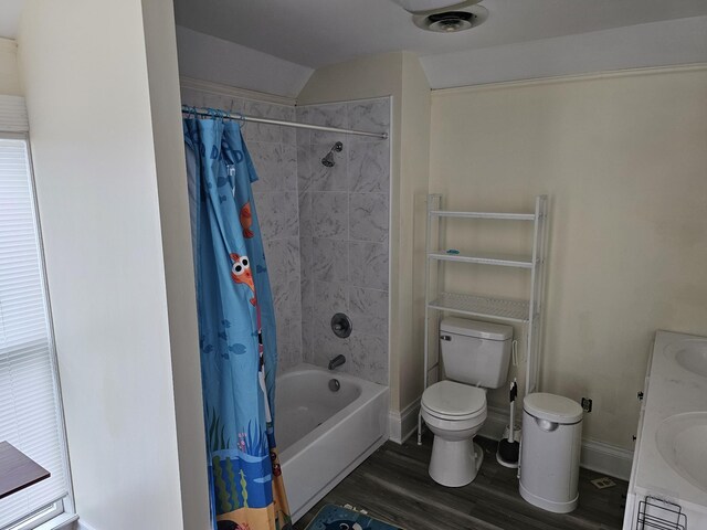 202 W Main St, Decherd, TN 37324 - bathroom with wood finished floors, toilet, shower / bath combo with shower curtain, baseboards, and vaulted ceiling