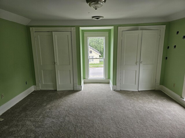 202 W Main St, Decherd, TN 37324 - unfurnished bedroom featuring carpet, baseboards, and two closets