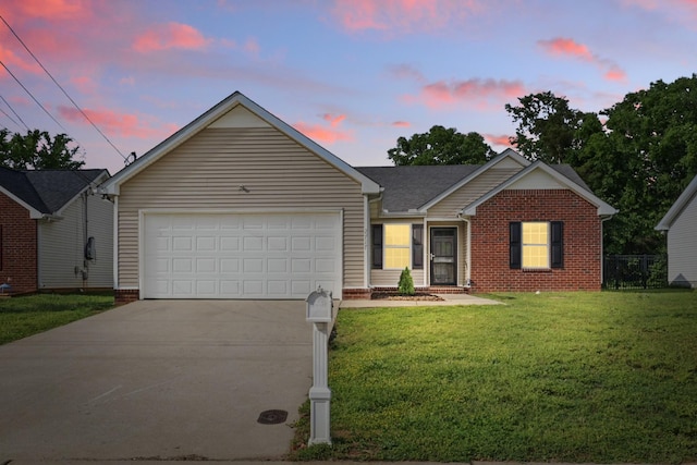 single story home featuring a yard, brick siding, driveway, and a garage