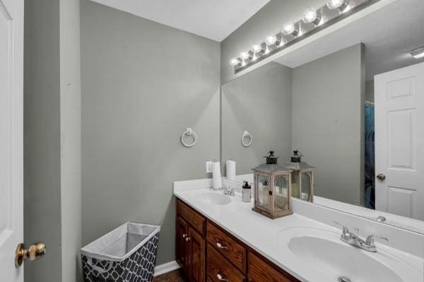 bathroom featuring a sink and double vanity