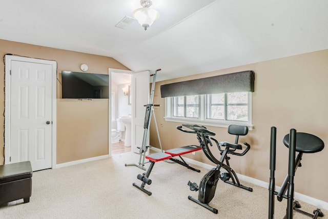 workout area with carpet flooring, baseboards, and vaulted ceiling