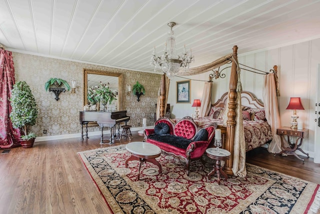 bedroom with ornamental molding, wood finished floors, baseboards, wallpapered walls, and a notable chandelier