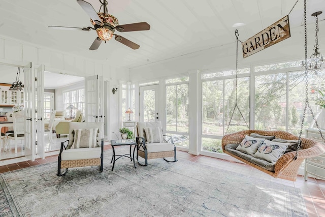 sunroom / solarium featuring french doors