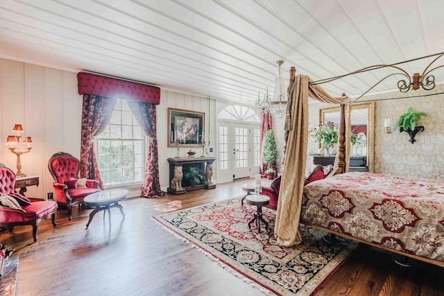 bedroom with wood finished floors and a fireplace