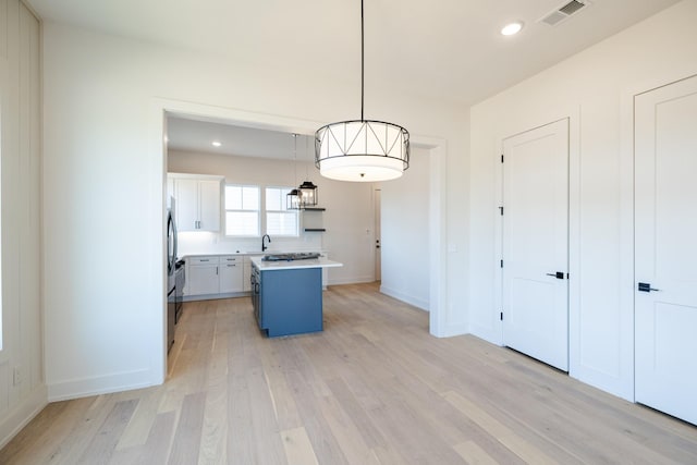 4060 Penfield Dr Unit E, Franklin, TN 37069 - kitchen featuring white cabinets, a sink, light wood finished floors, light countertops, and visible vents