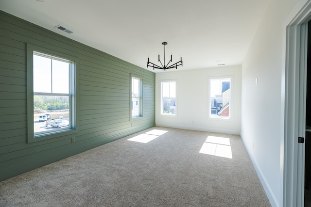 4060 Penfield Dr Unit E, Franklin, TN 37069 - spare room featuring visible vents, carpet flooring, a notable chandelier, and wood walls