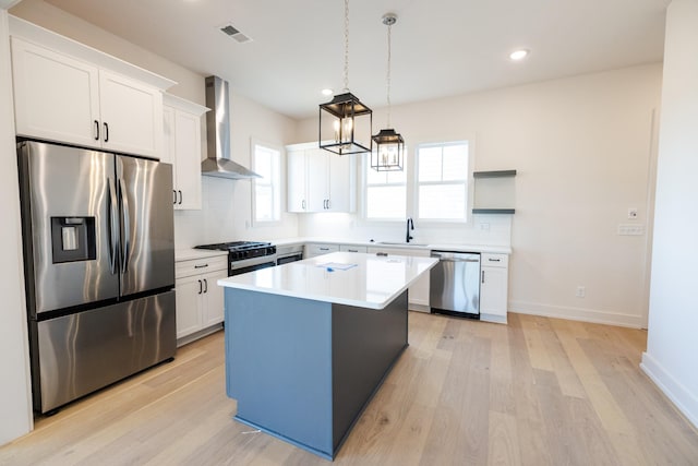 4060 Penfield Dr Unit E, Franklin, TN 37069 - kitchen featuring wall chimney range hood, visible vents, a center island, tasteful backsplash, and stainless steel appliances