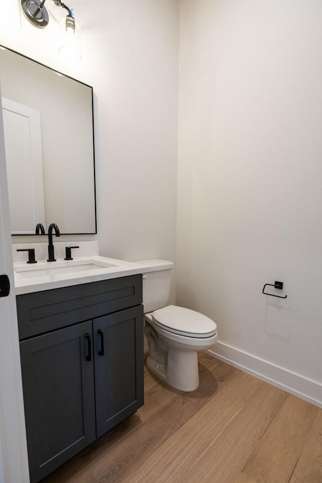 4060 Penfield Dr Unit E, Franklin, TN 37069 - half bathroom featuring vanity, baseboards, wood finished floors, and toilet