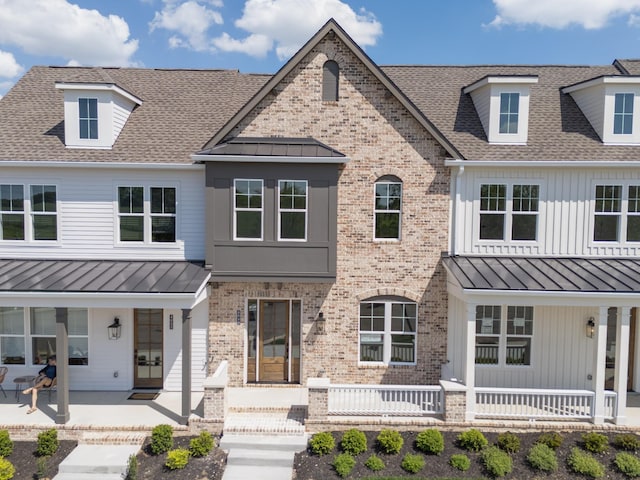 4060 Penfield Dr Unit E, Franklin, TN 37069 - view of front of home featuring a porch, a standing seam roof, roof with shingles, and brick siding
