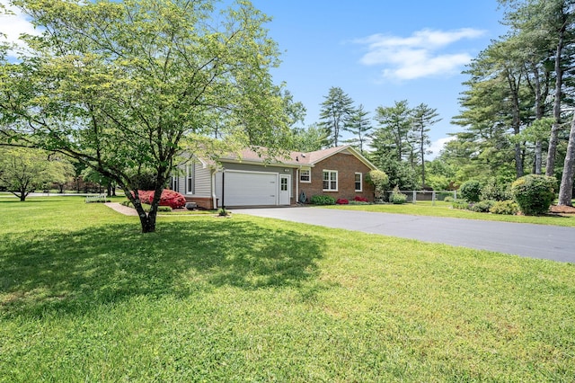 533 Mckaig Rd, Murfreesboro, TN 37127 - ranch-style house featuring fence, a front yard, brick siding, an attached garage, and driveway