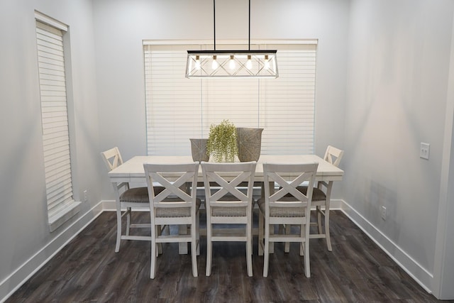 dining area with baseboards and dark wood-style flooring