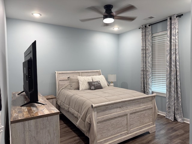 bedroom with baseboards, ceiling fan, dark wood-style floors, and visible vents