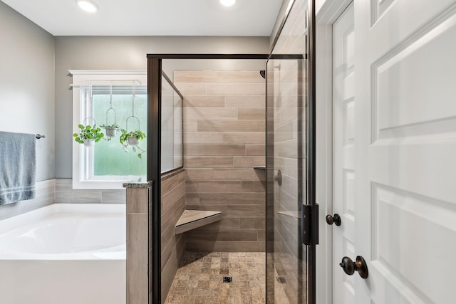 full bath featuring recessed lighting, a shower stall, and a garden tub