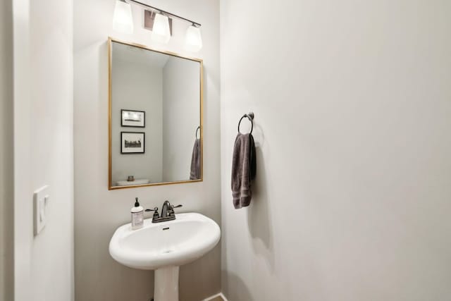 half bathroom featuring a sink