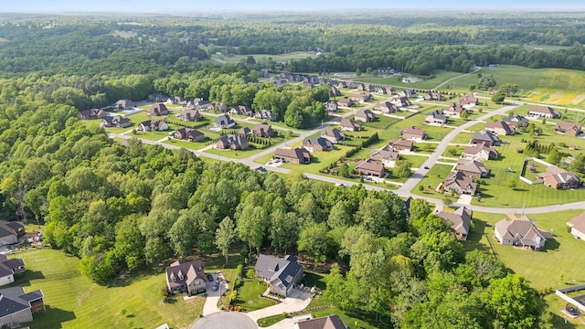 drone / aerial view featuring a residential view and a forest view