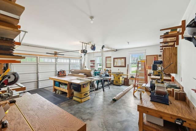 garage with a workshop area and a garage door opener