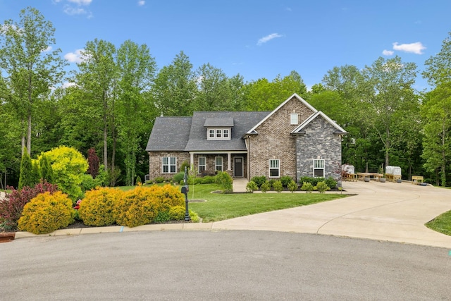 craftsman house featuring brick siding and a front lawn