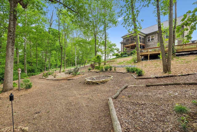 view of yard featuring a sunroom and a deck