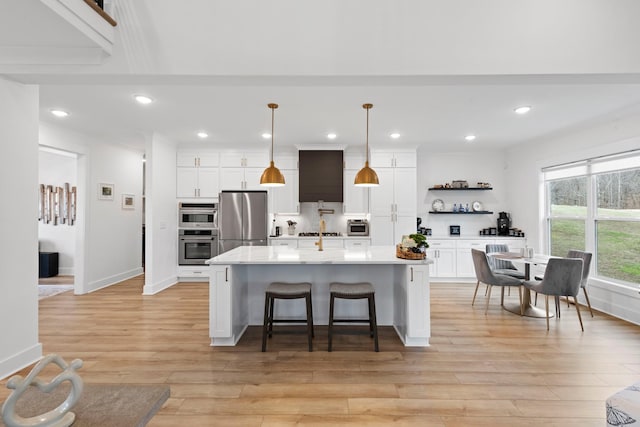 kitchen with light countertops, white cabinetry, open shelves, and appliances with stainless steel finishes
