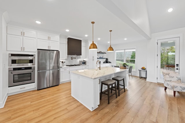 kitchen featuring white cabinetry, appliances with stainless steel finishes, and light wood-type flooring