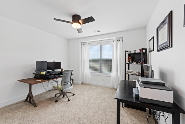 carpeted office with a ceiling fan, baseboards, and visible vents