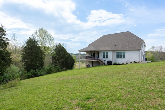 rear view of property featuring stairs, a yard, and a deck