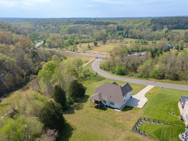 birds eye view of property with a wooded view